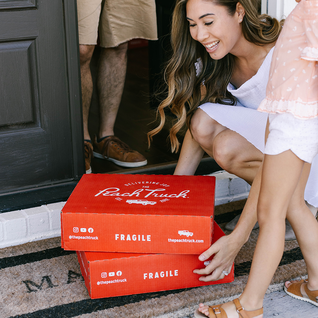 A family coming home to a delivery filled with peaches